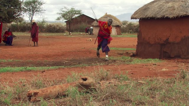 Young Masai man demonstrating his marksmanship with a spear