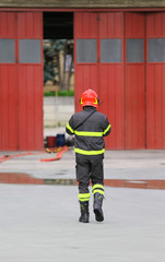 Firefighters in uniform with red helmet