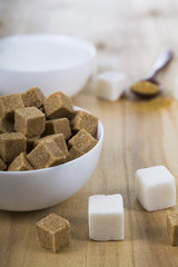 Cane and white sugar in a white bowls