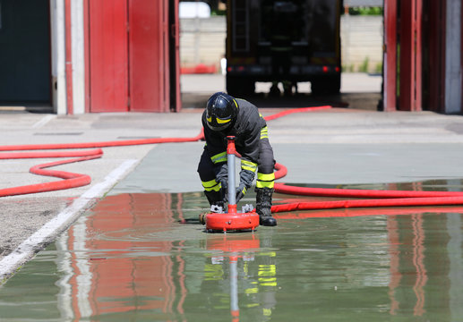 Firefighter positions a powerful fire hydrant