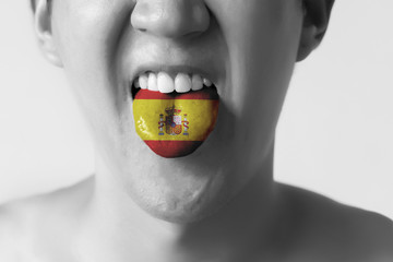 Spain flag painted in tongue of a man - indicating Spanish langu