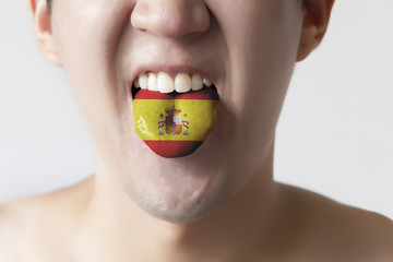 Spain flag painted in tongue of a man - indicating Spanish langu