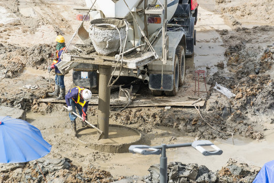 Construction workers are preparing pump for concrete for pouring