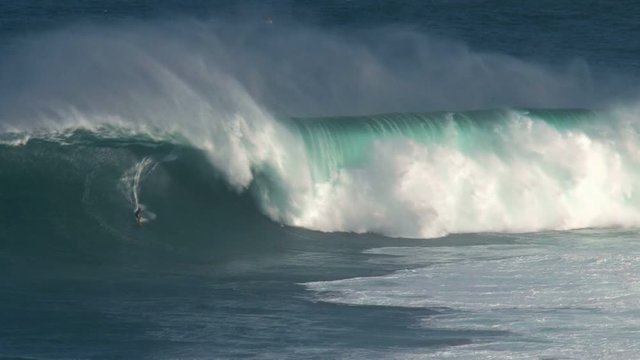 Crazy surfer at a massive wave surfing break called Jaws in at the north shore of the island of Maui, Hawaii