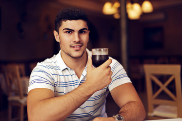 Handsome Man Raising Wine Glass in Toast