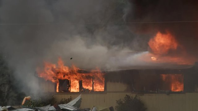 House engulfed in flames and smoke