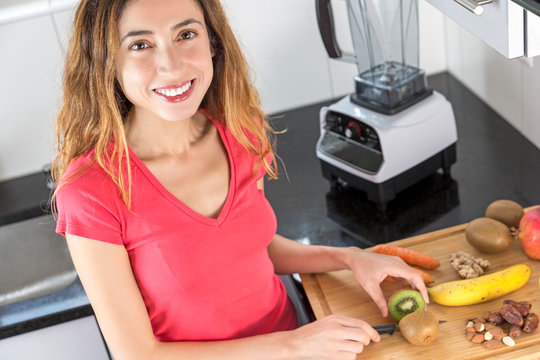 Woman preparing fruits for smoothie