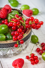Mix of fresh organic berries isolated on vintage wooden table background