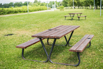 Wooden picnic table and benches in park
