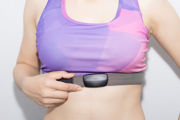 Woman in sport bra and heart rate monitor with tape isolated on