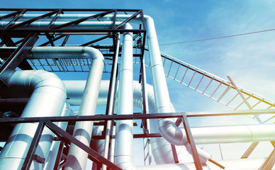 Industrial zone, Steel pipelines and valves against blue sky