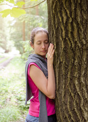 Woman embracing tree