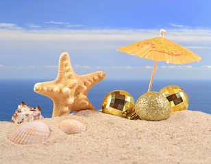 Christmas decorations seashells and starfish on a beach sand