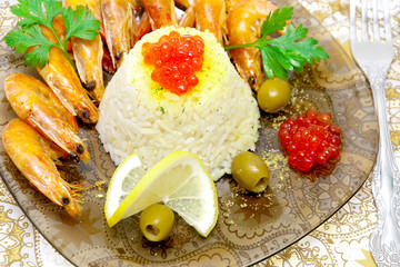 steamed rice with red caviar, shrimp, lemon and olives close-up