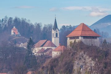 Fototapeta premium Kamnik, Slovenia - January 25, 2016. Architectural composition of Little Castle, Church of St. Joseph and main town cemetery with Calvary chapels.
