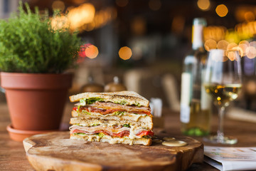 tasty grilled sandwich with sauce on the wooden plate in the restaurant