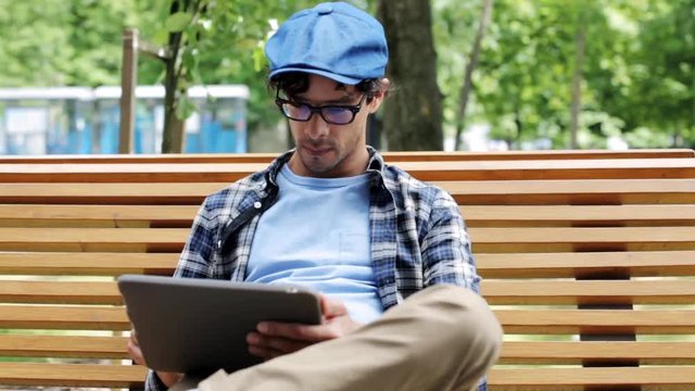 man with tablet pc sitting on city street bench 43