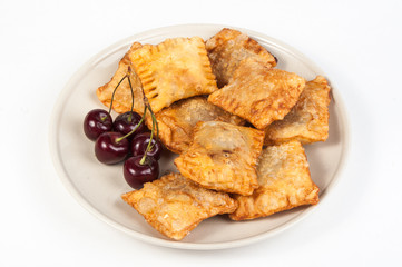 Patties stuffed with fresh cherries on a plate