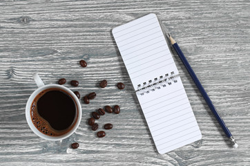 Cup of coffee and notepad