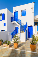 Typical white Greek house with blue doors and windows on island of Mykonos, Greece