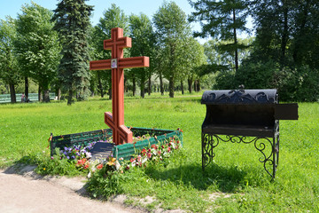 Orthodox funeral cross and the furnace on the place of brick pla