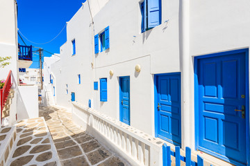 A view of whitewashed street with blue doors of houses in beautiful Mykonos town, Cyclades islands, Greece © pkazmierczak