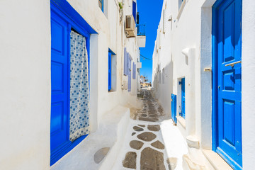 A view of whitewashed street with blue doors in Mykonos town, Cyclades islands, Greece