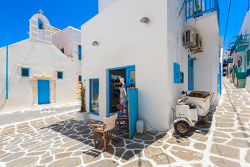 Square with church and local shop on whitewashed street with typical Greek architecture in beautiful Mykonos town, Cyclades islands, Greece © pkazmierczak