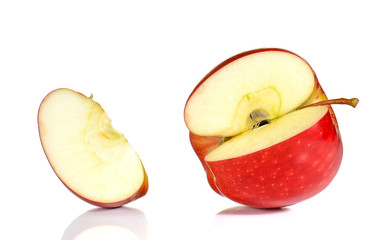 Red Apple cut pieces on white background.