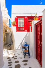 A table with two chairs on whitewashed street in beautiful Mykonos town, Cyclades islands, Greece © pkazmierczak