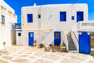 Typical Greek house blue windows and doors on whitewashed street in beautiful Mykonos town, Cyclades islands, Greece