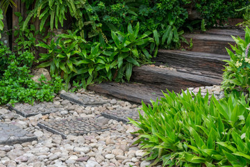 stone walk way and wood stairs in the garden - 114683297