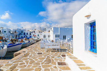 A view of Naoussa port with fishing boats and taverna buildings, Paros island, Cyclades, Greece