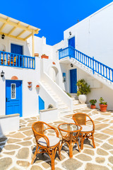 NAOUSSA VILLAGE, PAROS ISLAND - MAY 18, 2016: Table with chairs on patio of beautiful Greek style holiday apartments in Naoussa village, Paros island, Cyclades, Greece.