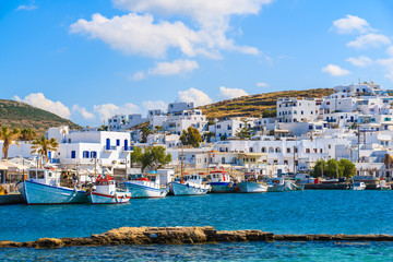 A view of Naoussa port with white houses and traditional fishing boats, Paros island, Greece