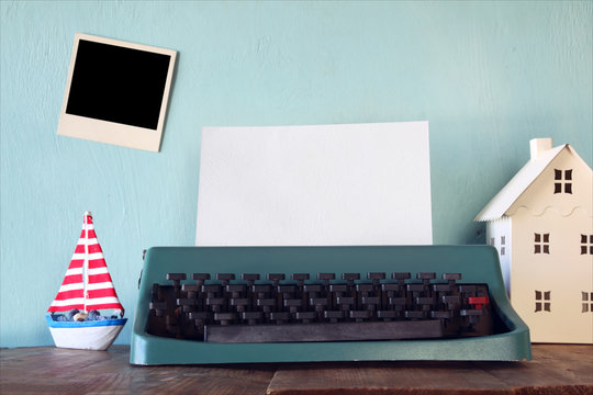 vintage typewriter with blank page and empty photo frame