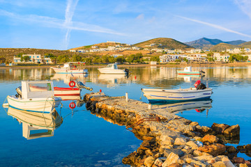 Fishing boats mooring in Naoussa port at sunrise time, Paros island, Cyclades, Greece