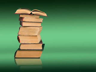 Stack of books on the color gradient background, space for text