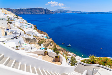 Steps to beautiful Oia village with typical white architecture and view of caldera, Santorini...