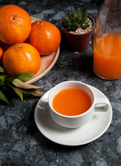 Fresh orange fruits and juice on marble table. Flat lay.