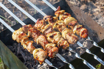 Barbecue skewers with grilled pork meat on the brazier