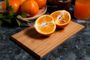 Fresh orange fruits and juice on marble table. Flat lay.