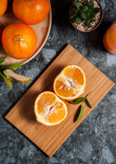 Fresh orange fruits and juice on marble table. Flat lay.