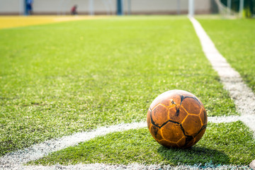 Fototapeta na wymiar old football ball on coner in football field