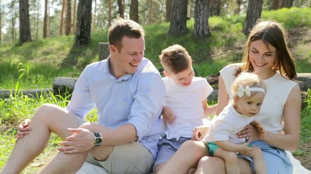 Happy family of four on picnic at summer sunny day HD