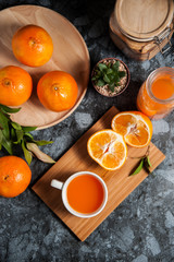 Fototapeta na wymiar Fresh orange fruits and juice on marble table. Flat lay.