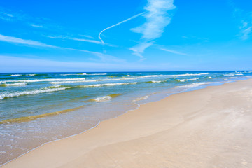 A view of beach and waves on blue Baltic Sea, Lubiatowo coastal village, Poland
