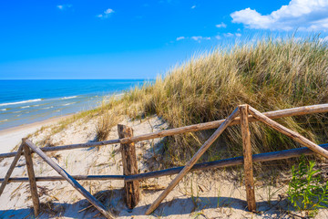 Fototapeta na wymiar Entrance to idyllic sandy beach in Bialogora coastal village, Baltic Sea, Poland