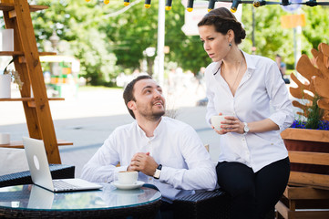 Business Team man and woman at Cafe having a conversation using laptop. Working Meeting Concept