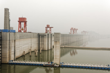 A veil of fog sits over the huge Three Gorges Dam wall in Sandouping,  Hubei Province, China.